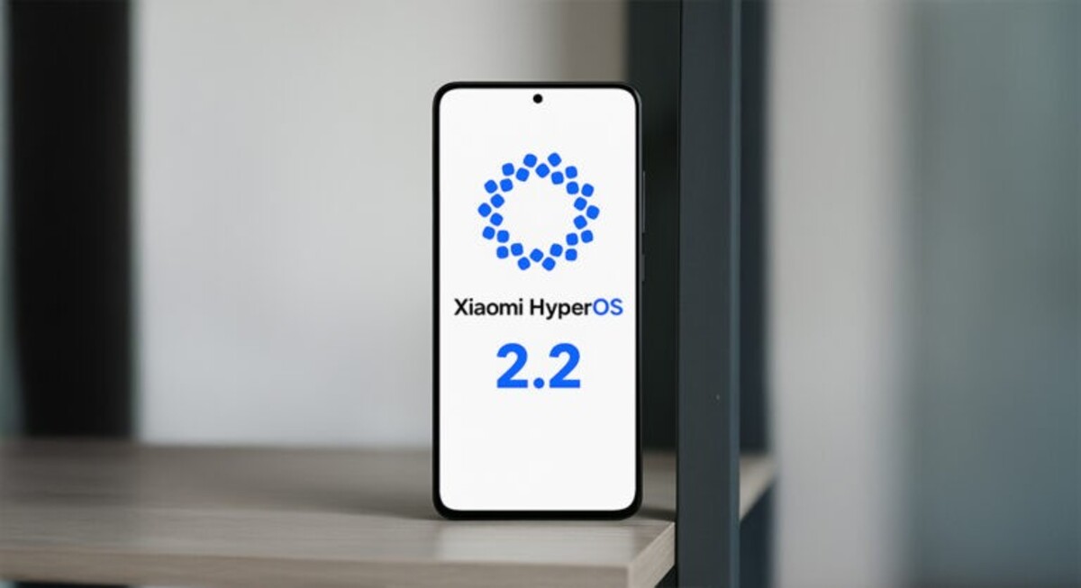 Cell phone showing the Xiaomi HyperOS 2.2 logo on a beige shelf with a blurred background.