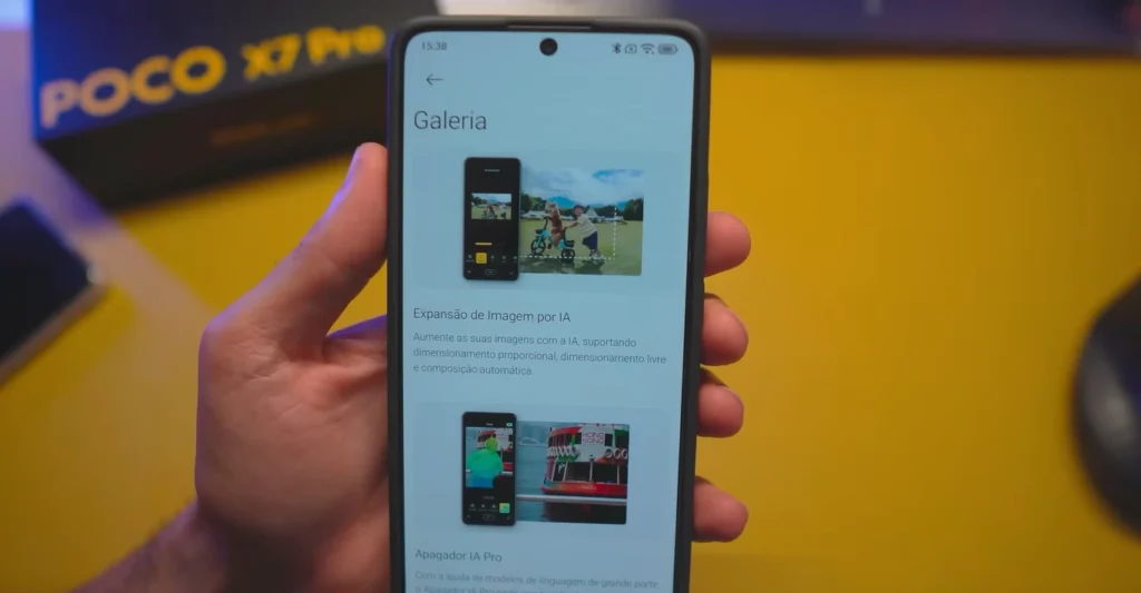 Hand holding a Xiaomi smartphone with the screen displaying HyperOS 2.2's Gallery "AI Image Expansion" and "AI Eraser Pro" features.