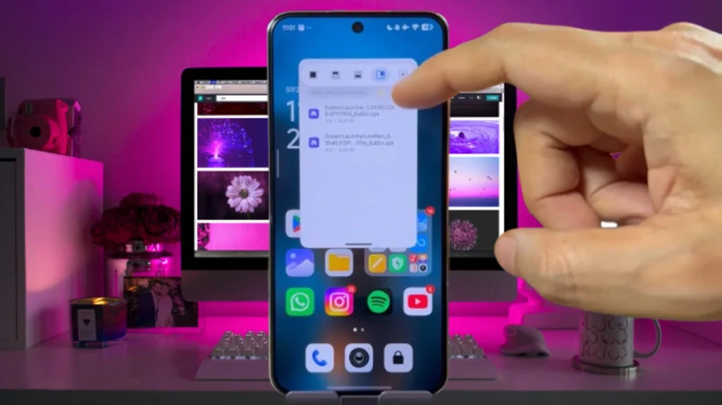 A finger touching a smartphone screen displays a floating window with files related to HyperOS Launcher 2, overlaying the home screen with app icons.