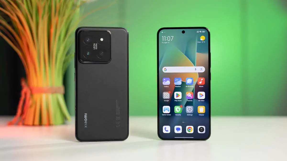 Two Xiaomi 13T smartphones, one showing the black back and the other the HyperOS 2.2 home screen.