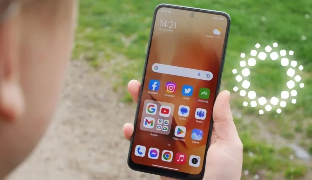 A person holds a Xiaomi smartphone displaying the home screen with various app icons.
A person is shown holding a Xiaomi smartphone, potentially running the HyperOS 3 Beta Test, indicated by the phone's interface and the surrounding context. The device's home screen is visible, showcasing a clean layout of app icons.