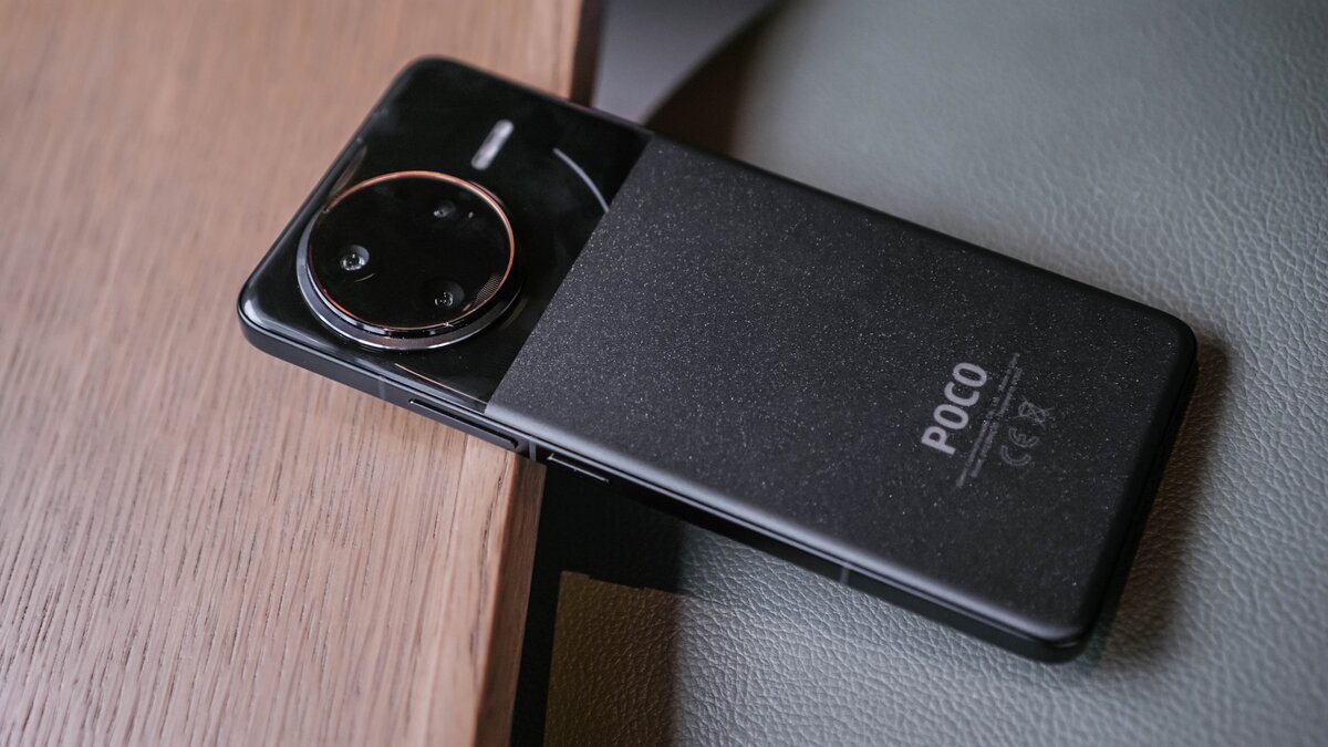 POCO F7 Ultra with stable Global HyperOS 3 Global, lying on a wood and leather surface.