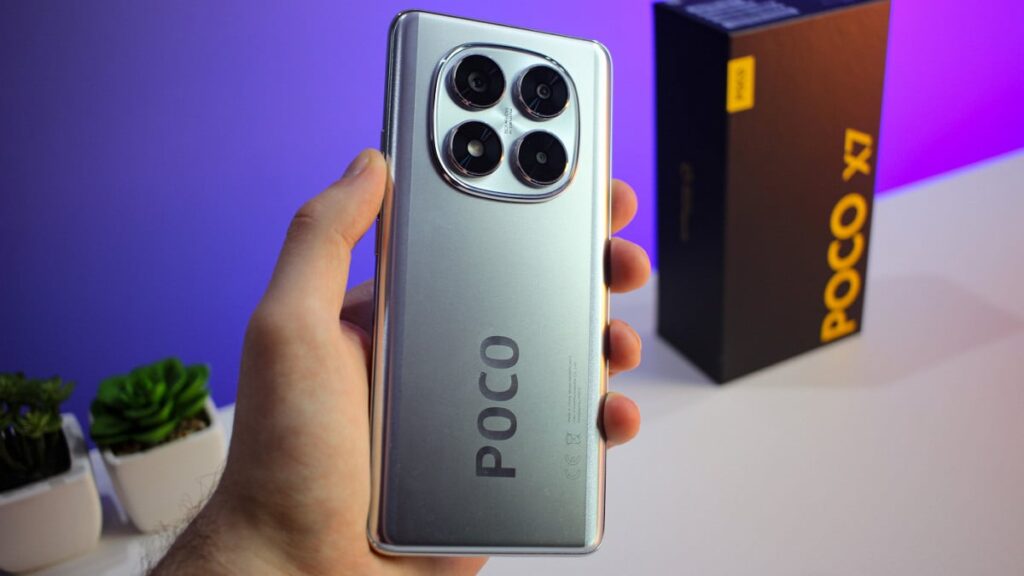 The POCO X7 smartphone in silver, featuring HyperOS 3 Global, highlights the rear camera module and the device's box in the background.